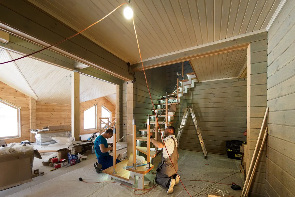 Carpenters building a staircase in a new construction home