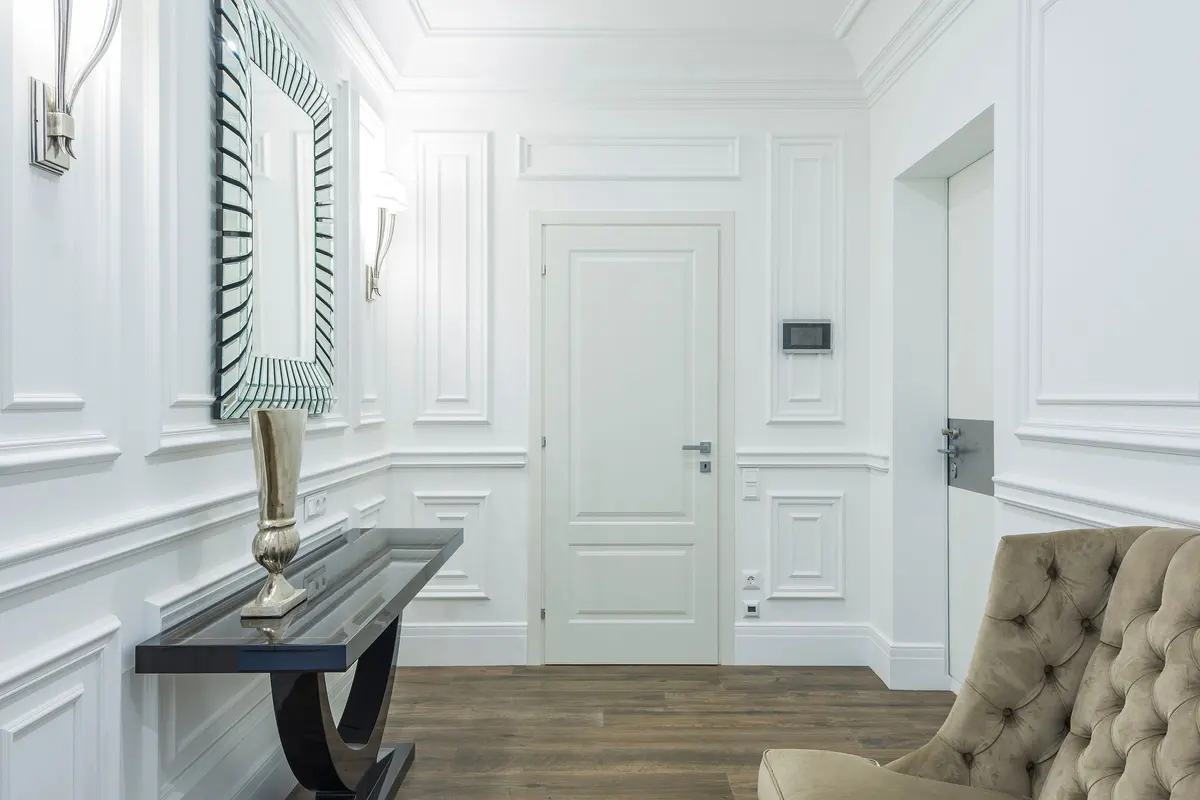 White room with classic wall paneling and moldings