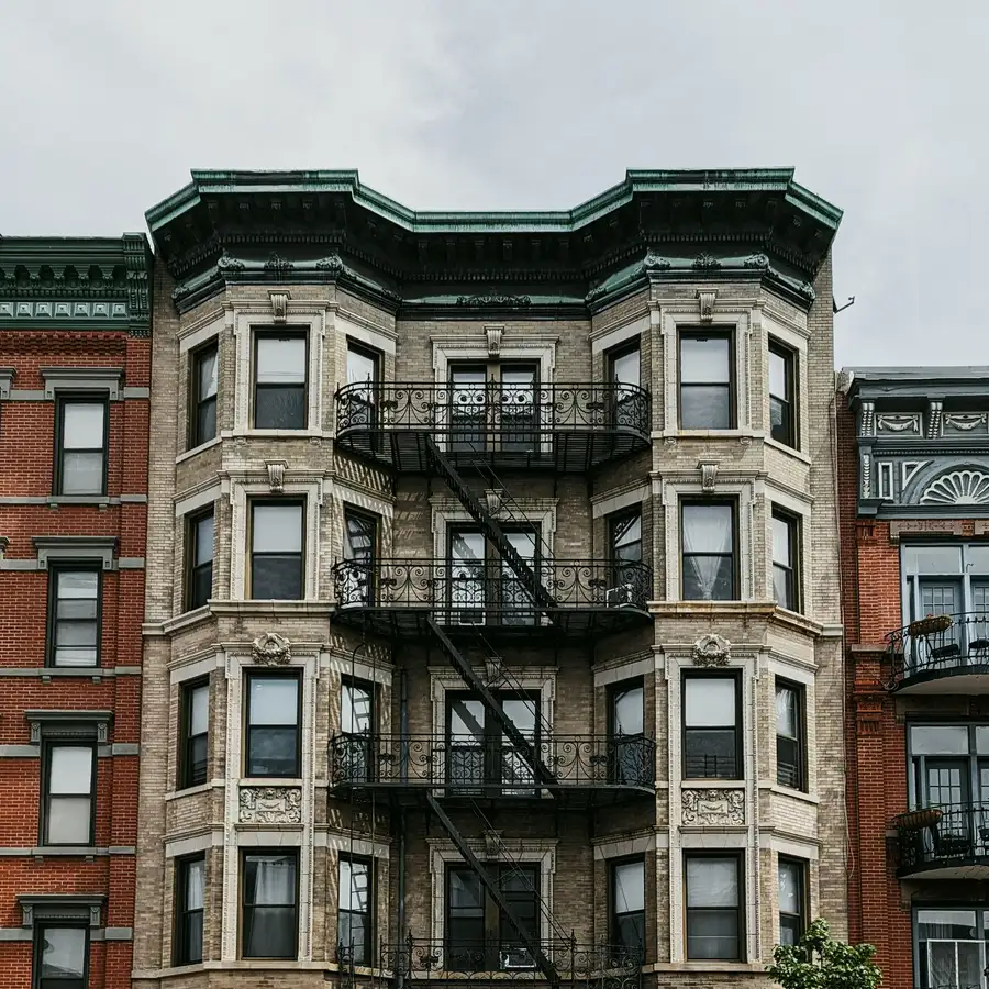 Historic brownstone building with fire escapes in Hoboken, NJ