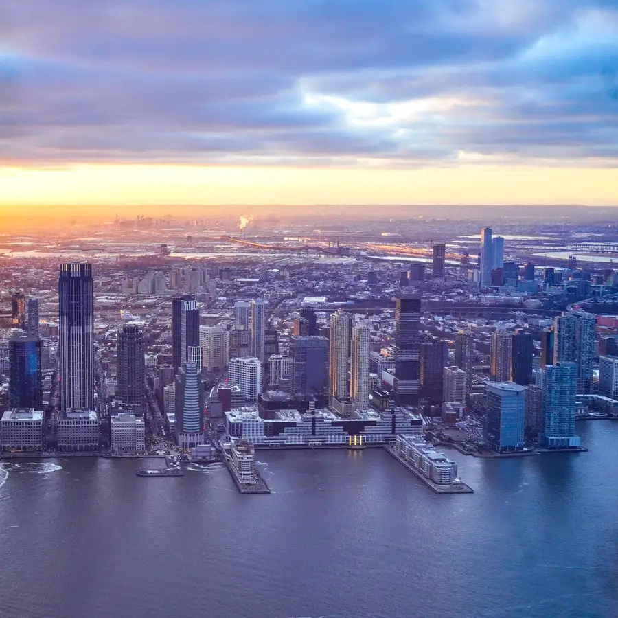 Aerial view of Jersey City, NJ along the Hudson River at sunset