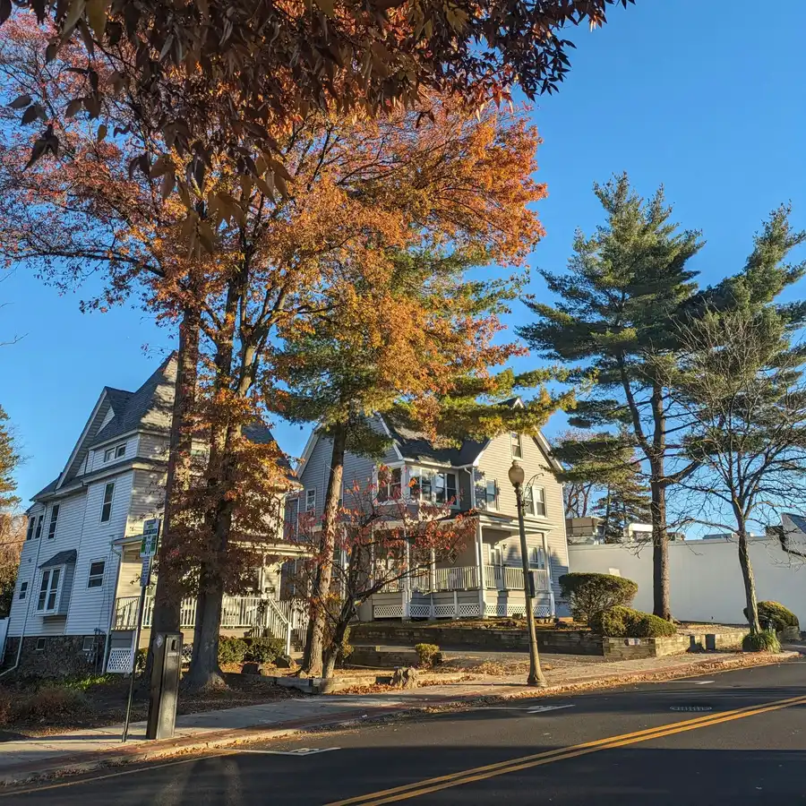 Tree-lined residential street with colonial homes in Ridgewood, NJ in autumn