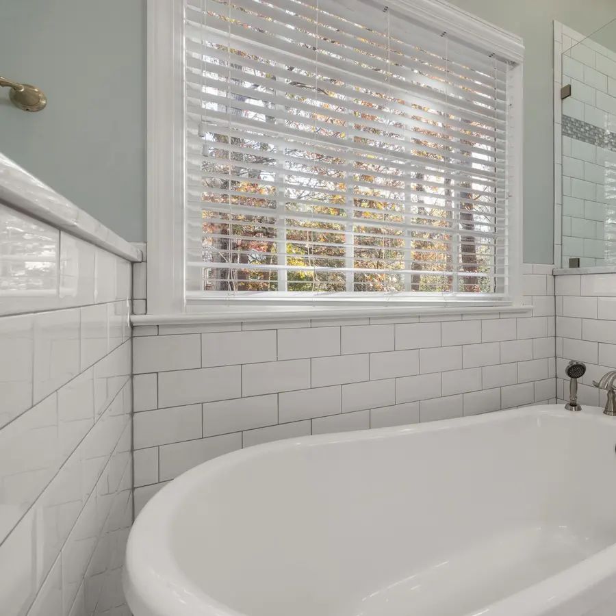 Remodeled bathroom with a freestanding tub, subway tile and a glass shower
