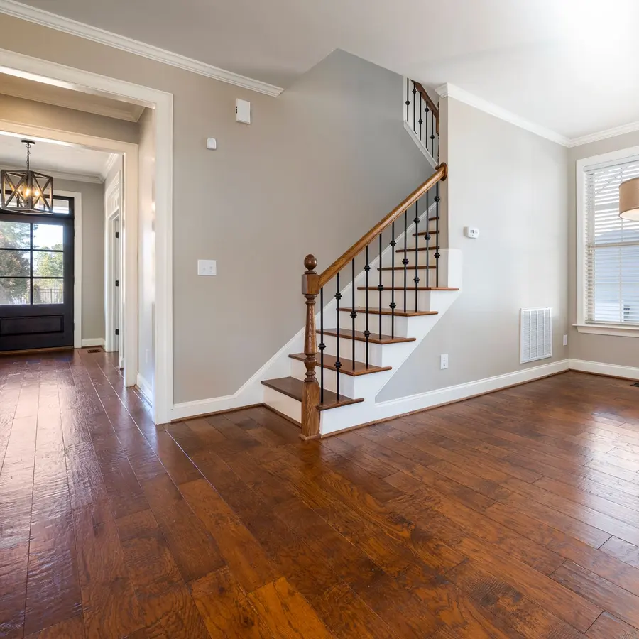 Entry with new stair trim, baseboards and door casing in a renovated home